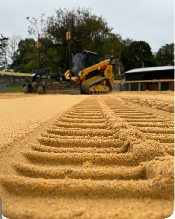 Skid steer laser grading the sand surface of an equestrian riding arena in New Tripoli, PA