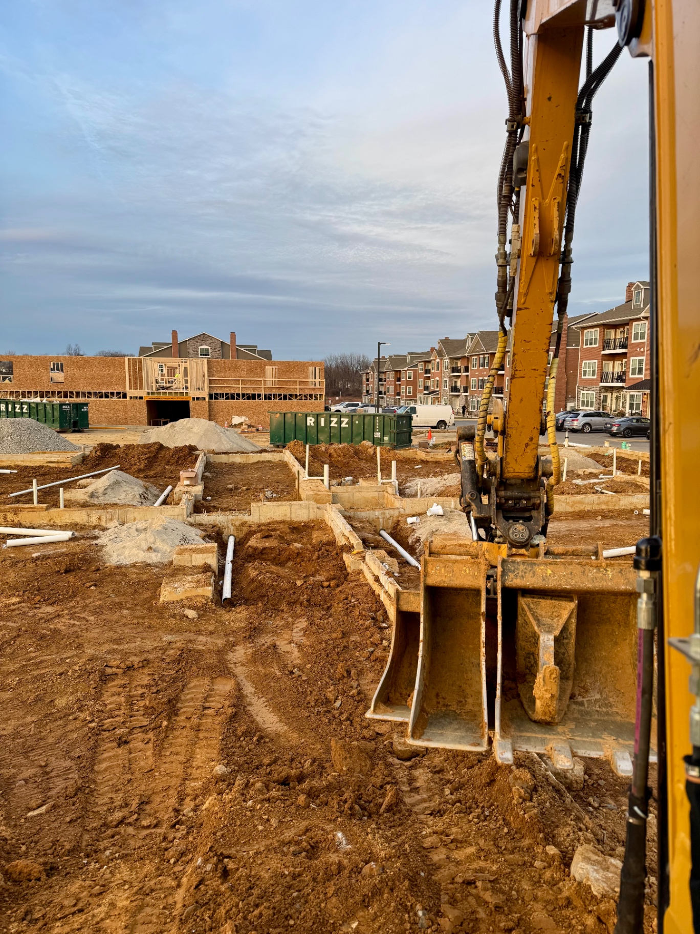 Excavator at work on a commercial foundation and utility job site