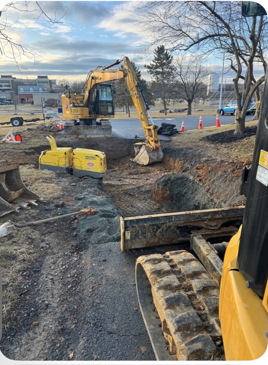 Excavator and compaction equipment repairing a water line at Northampton Community College